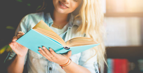 Young woman reading book