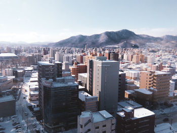 High angle view of buildings in city against sky