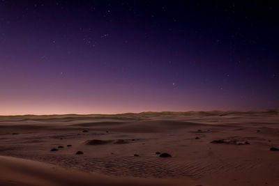 Scenic view of desert against sky at night