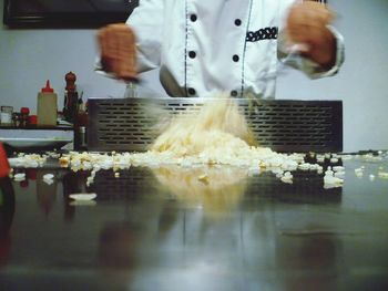 Cropped image of man preparing food in factory
