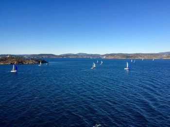 Scenic view of sea against clear blue sky