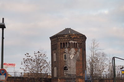 Low angle view of built structure against cloudy sky