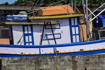 Low angle view of yellow building against blue sky