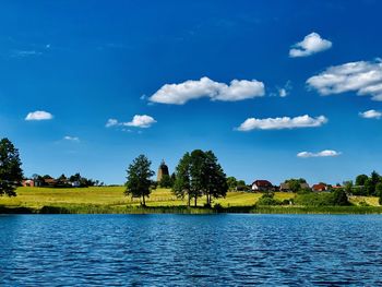 Scenic view of lake against blue sky