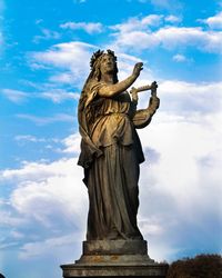 Low angle view of statue against cloudy sky