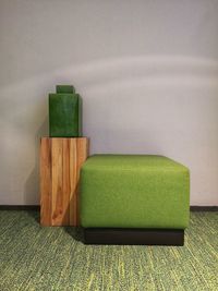Close-up of empty chair against wall at home