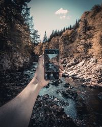 Man photographing through mobile phone in water