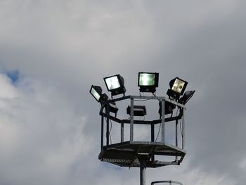 Low angle view of illuminated street light against sky