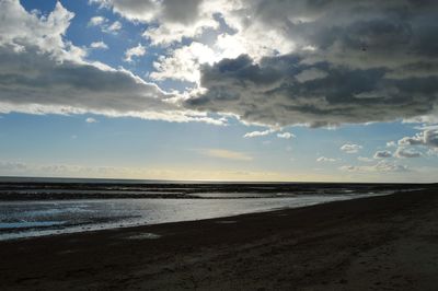 Scenic view of beach against sky during sunset