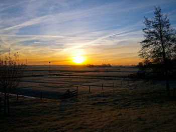 Scenic view of beach against sky during sunset
