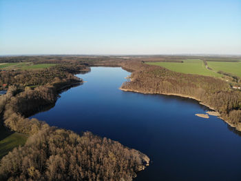 Scenic view of lake against clear blue sky