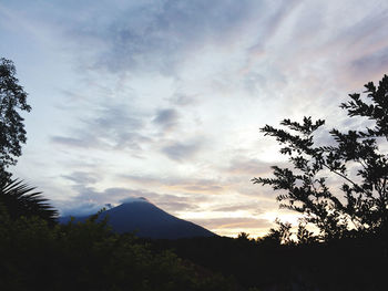 Scenic view of silhouette mountains against sky at sunset