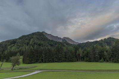 Scenic view of golf course against sky