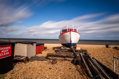 Lifeguard hut on land against sky