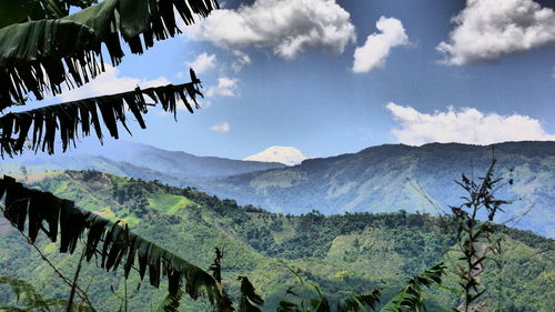 Scenic view of mountains against cloudy sky