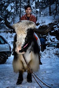 Full length of man with snow in car