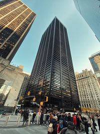 Low angle view of modern buildings in city against sky