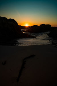 Scenic view of beach against sky during sunset