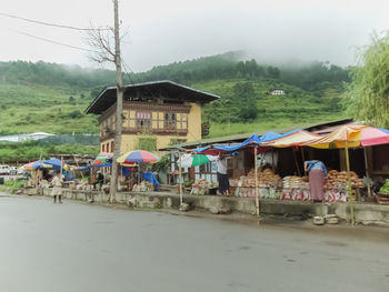 People in front of built structure against sky