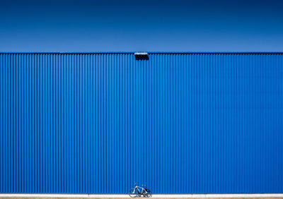 Low angle view of blue container against clear sky