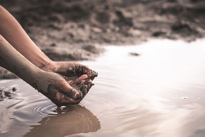 Midsection of person in sea