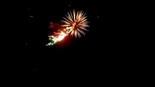 Low angle view of firework display at night