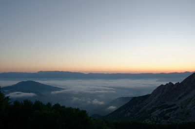 Scenic view of silhouette mountains against sky during sunset