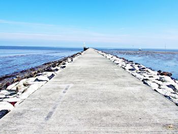 Pier over sea against sky