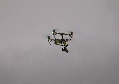 Low angle view of helicopter flying against sky