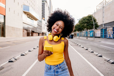 Portrait of young woman standing in city