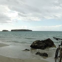 Scenic view of sea against cloudy sky