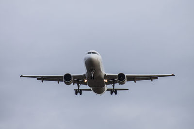 Low angle view of airplane against sky