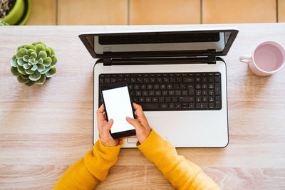 High angle view of man using laptop on table