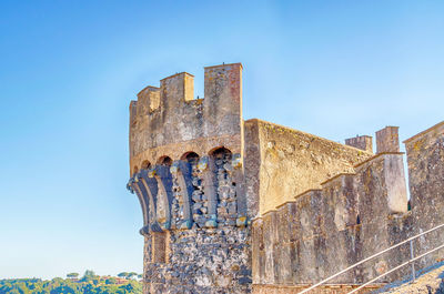 Low angle view of old building against blue sky