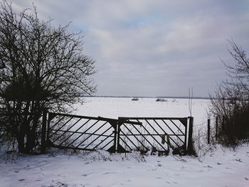 Fence against cloudy sky