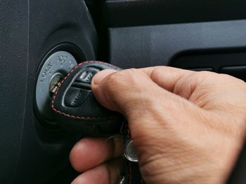 Close-up of man holding car key