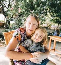 Portrait of a smiling girl sitting outdoors