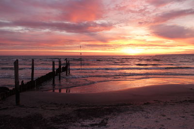 Scenic view of beach against sky during sunrise