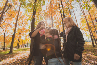 People standing by tree during autumn