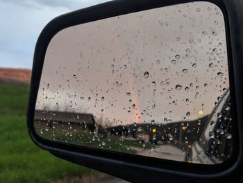 Raindrops on windshield seen through wet glass window