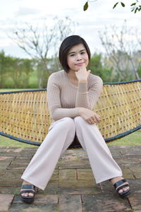 Portrait of woman sitting on bench