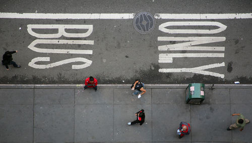 High angle view of people walking on road