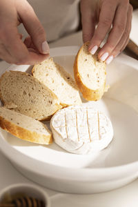 Cropped hand of person preparing food