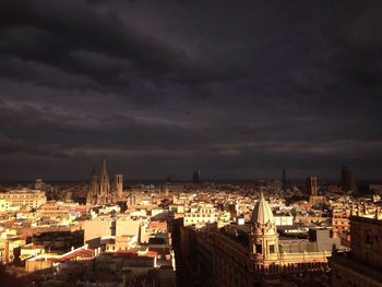 Cityscape against cloudy sky