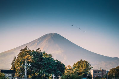 Scenic view of mountains against clear blue sky