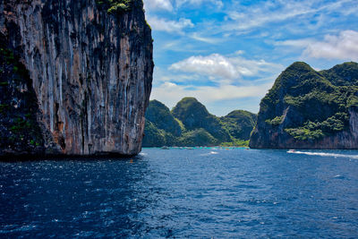 Rock formation in sea against sky