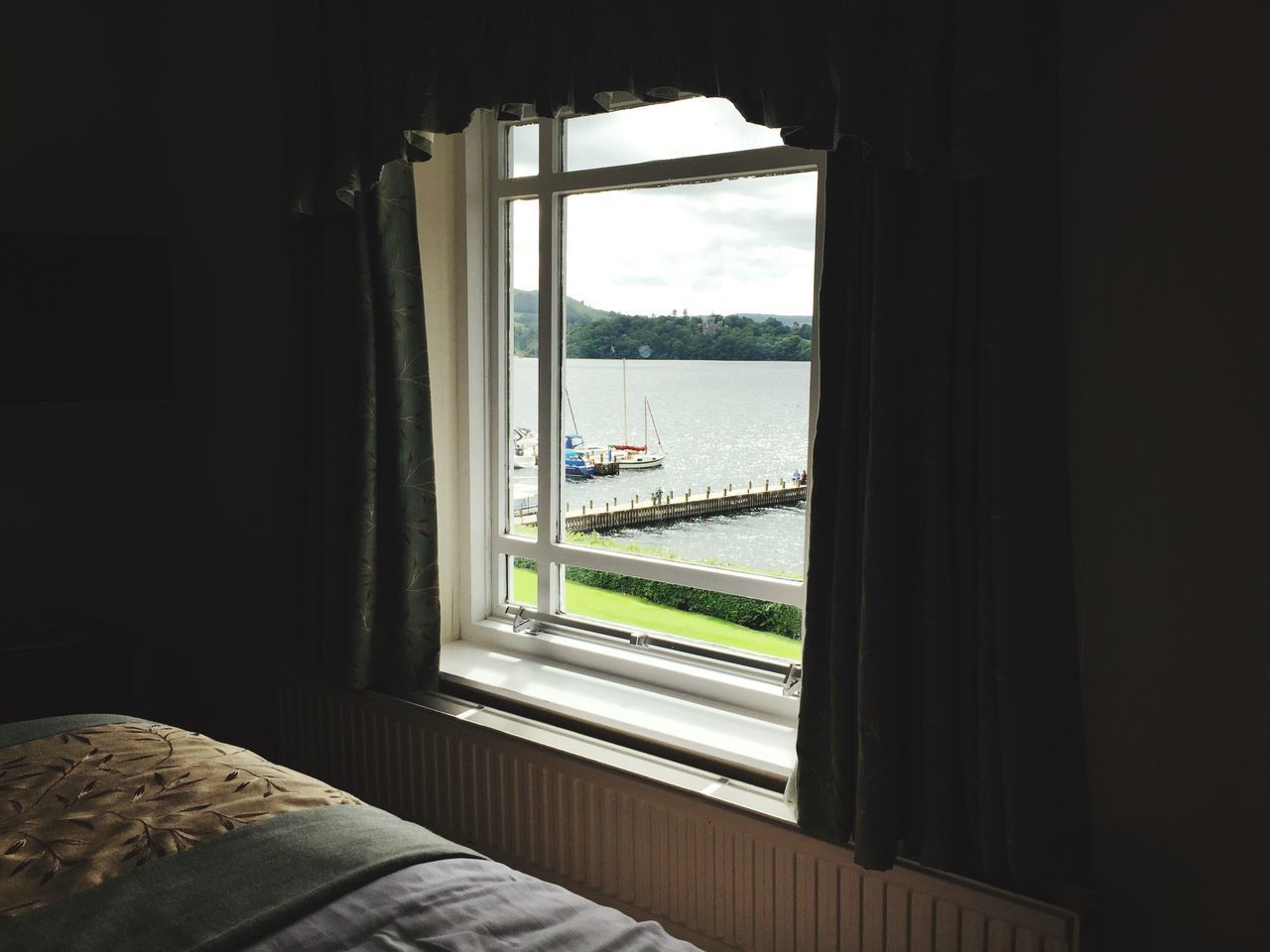 window, indoors, glass - material, transparent, water, sea, sky, architecture, built structure, looking through window, day, house, home interior, no people, door, nature, sunlight, horizon over water, absence, reflection