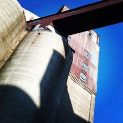 Low angle view of built structure against clear blue sky