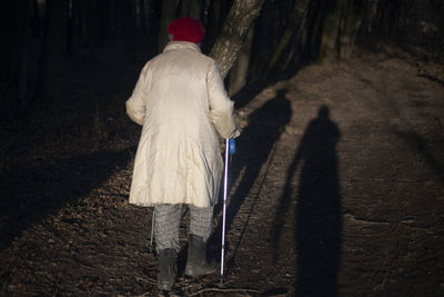 Rear view of people walking on road