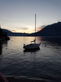 Sailboats on sea against sky during sunset